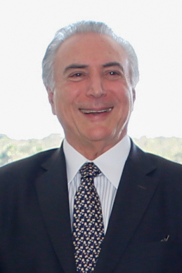 an older man wearing a suit and tie