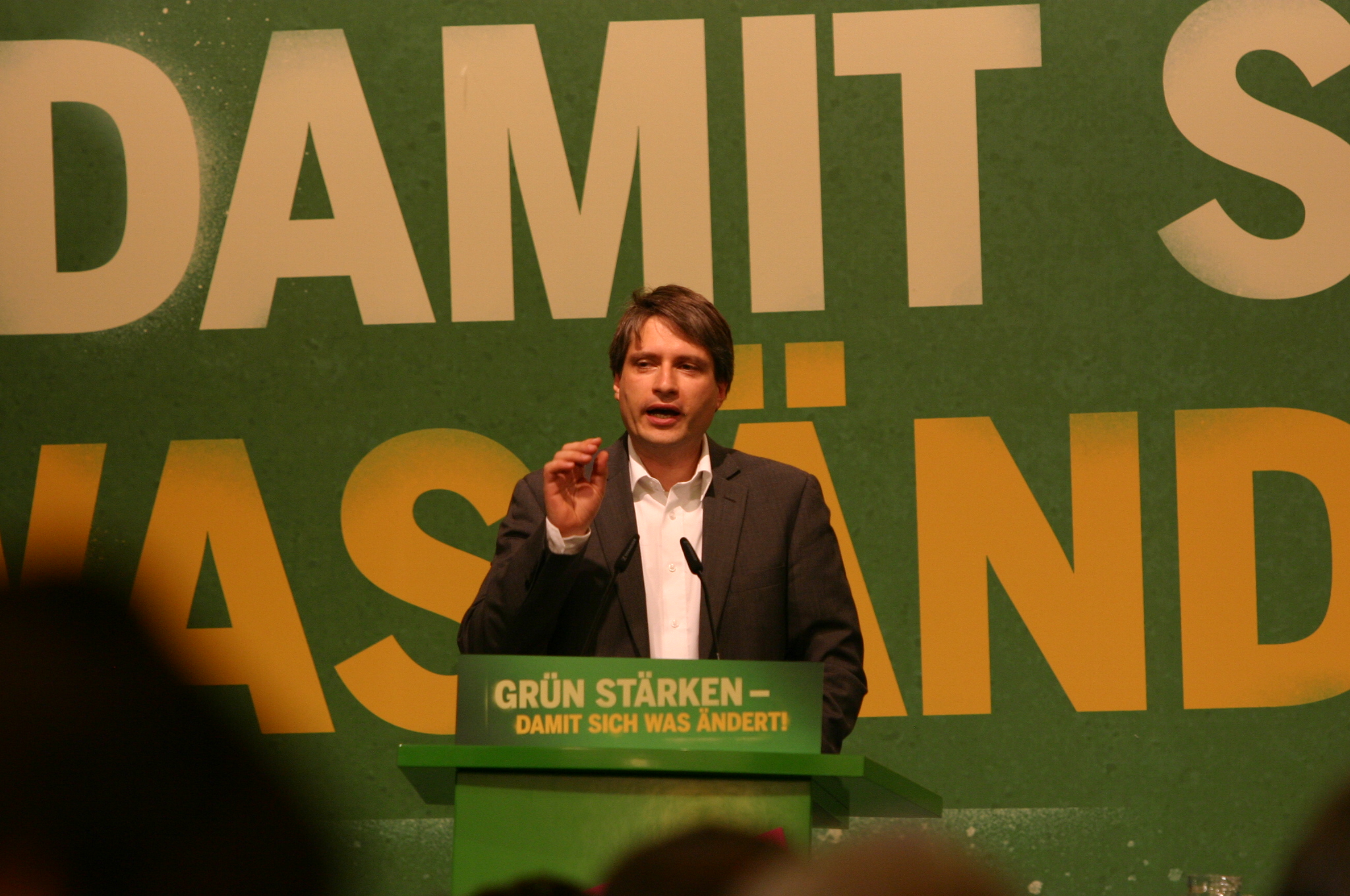 a man stands at a podium giving a lecture