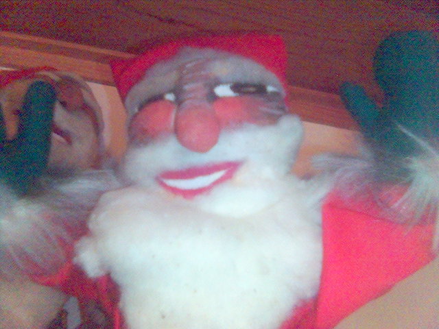 an older santa claus posed for a po