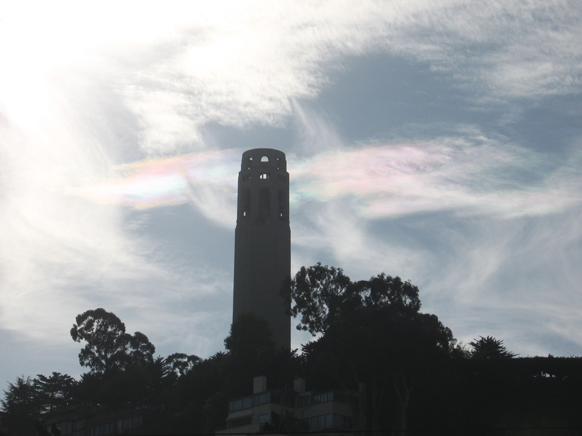 the sun shines over a tall clock tower