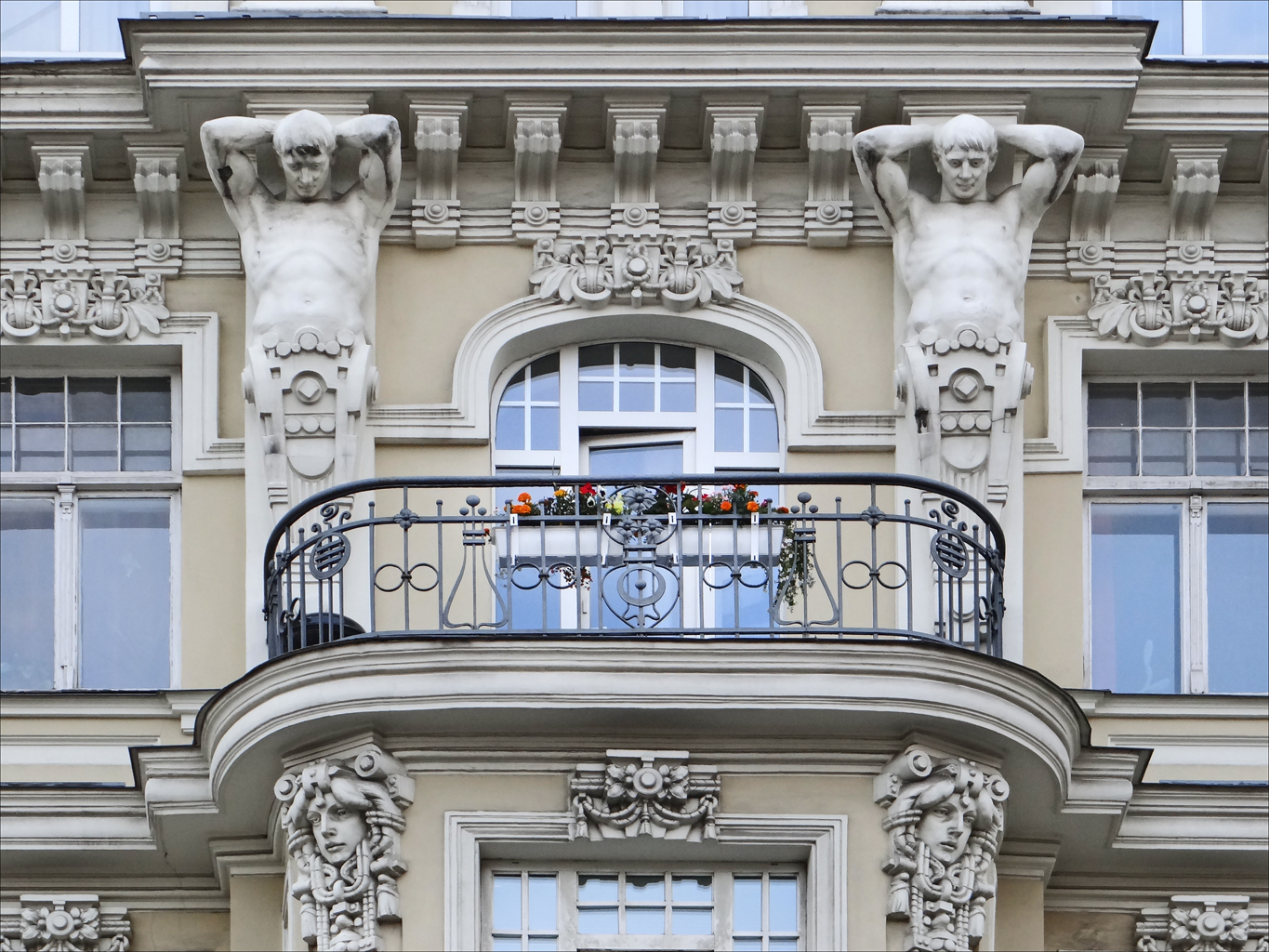a balcony on a big building with some gargoyle around it