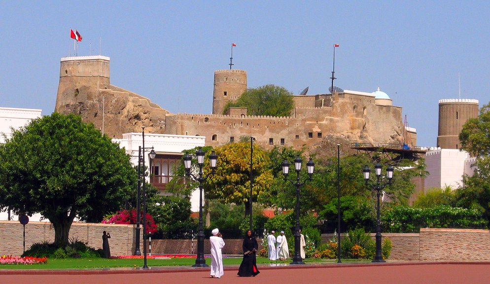 two people walking in a park near the castle