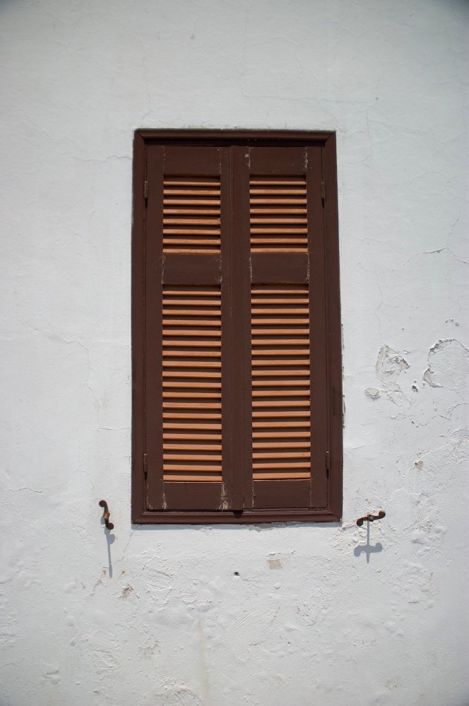 a window with wooden slats above it