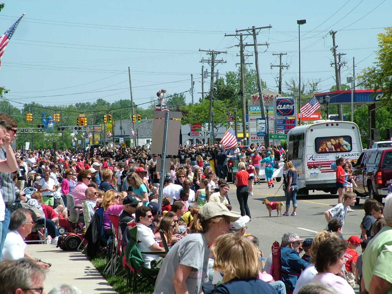 the people are walking on the street in front of a large crowd