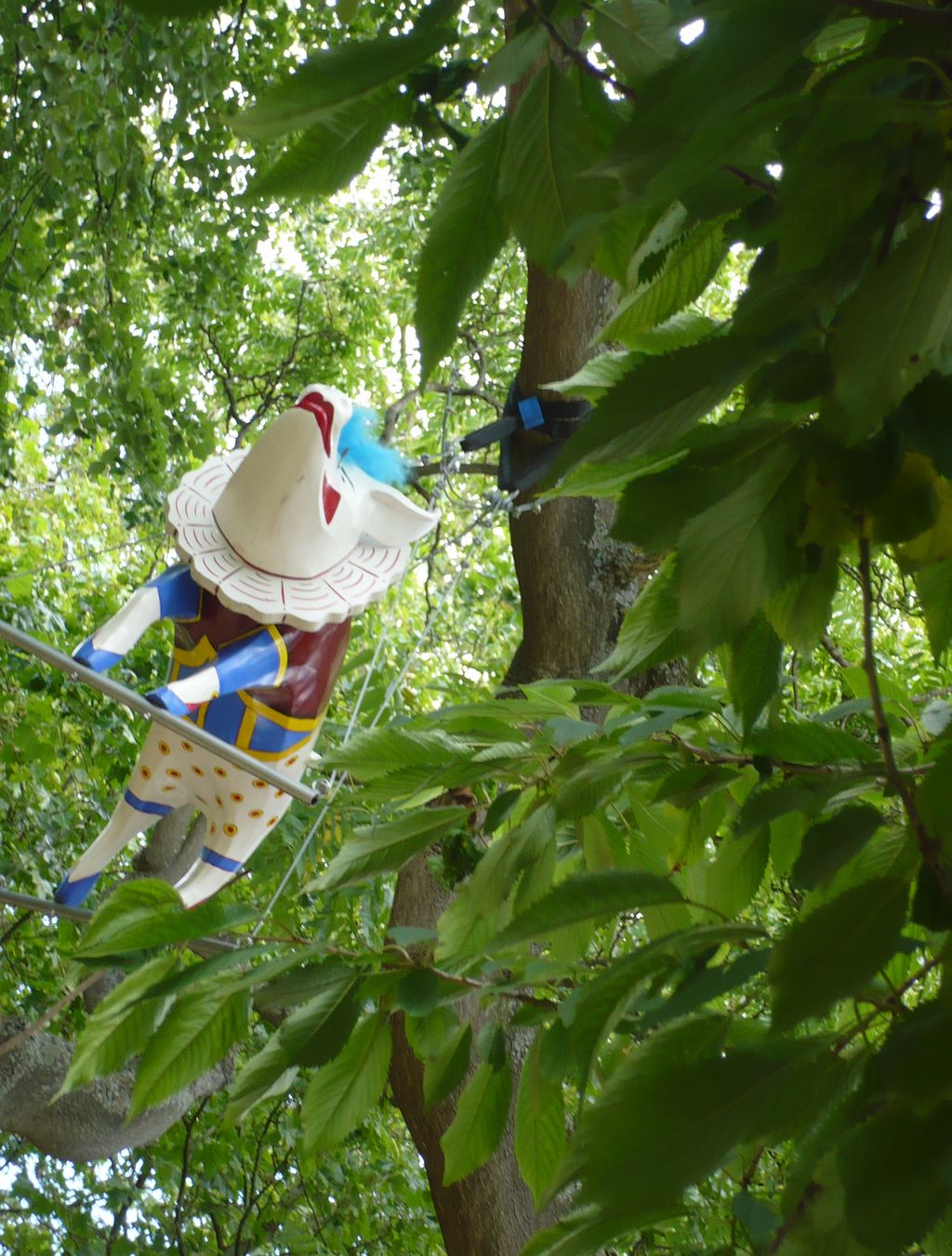 a colorful sculpture is shown in the tree