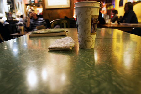 a cup and napkin sitting on top of a table