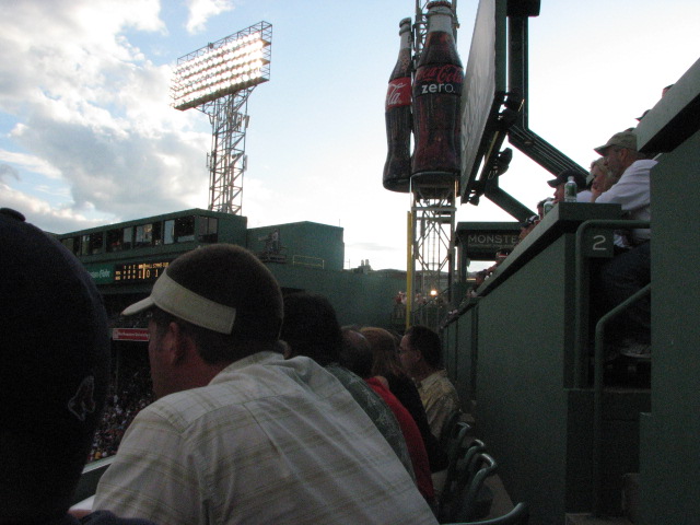 people at a baseball game and many watching