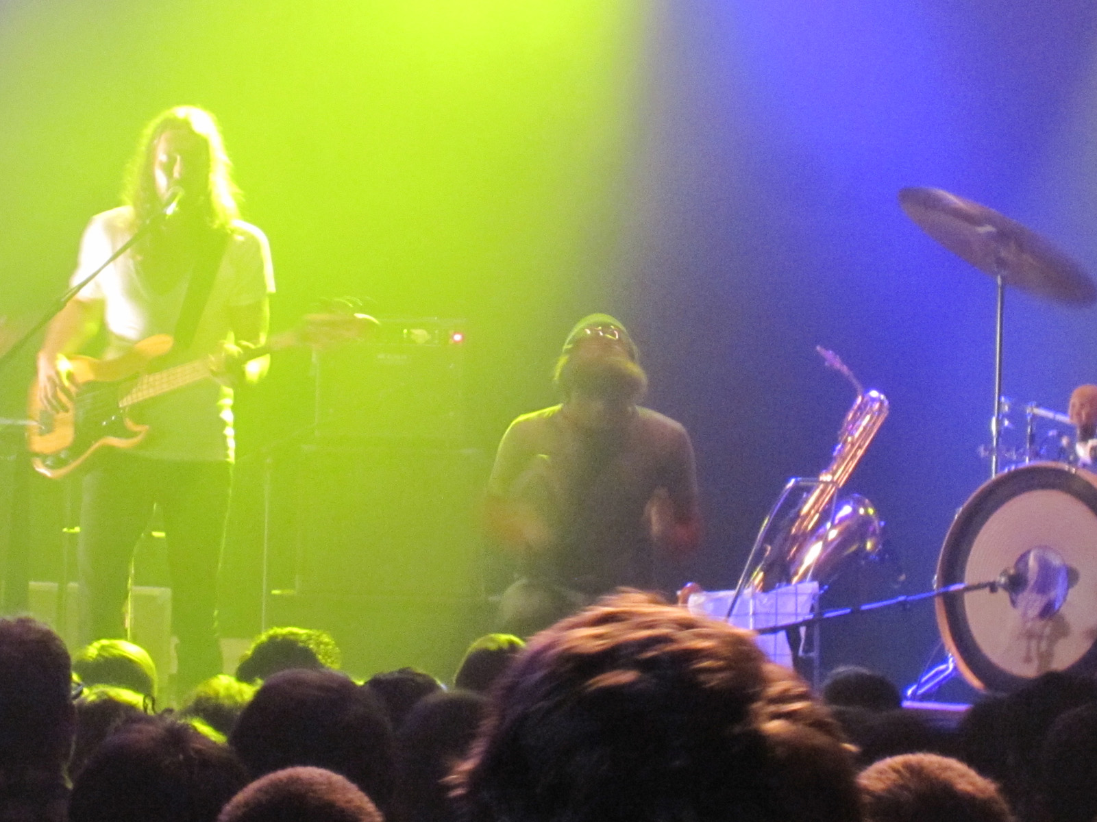 a band on stage with lights above them