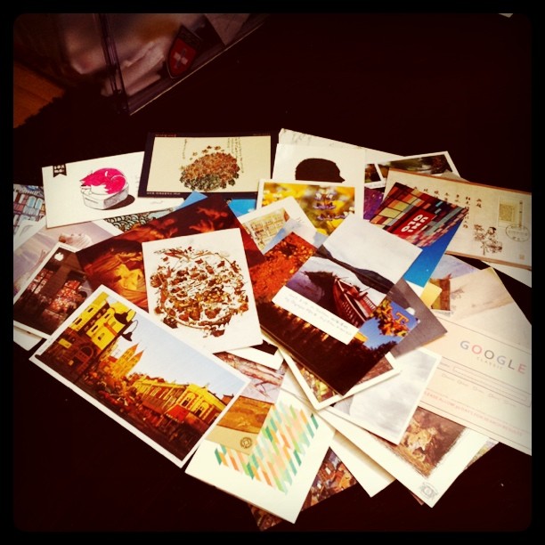 a pile of pictures, postcards and cards on the floor