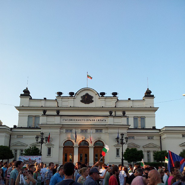 a large group of people gathered outside a large building