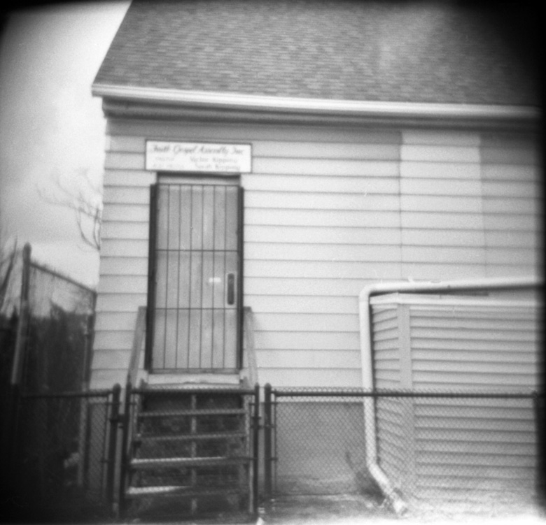 black and white pograph of a door at a small house