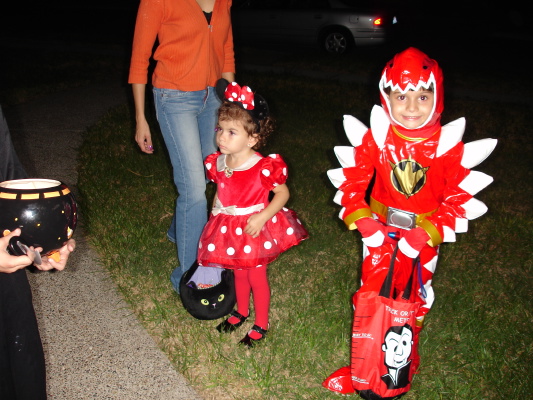 a woman standing next to a little girl in costume