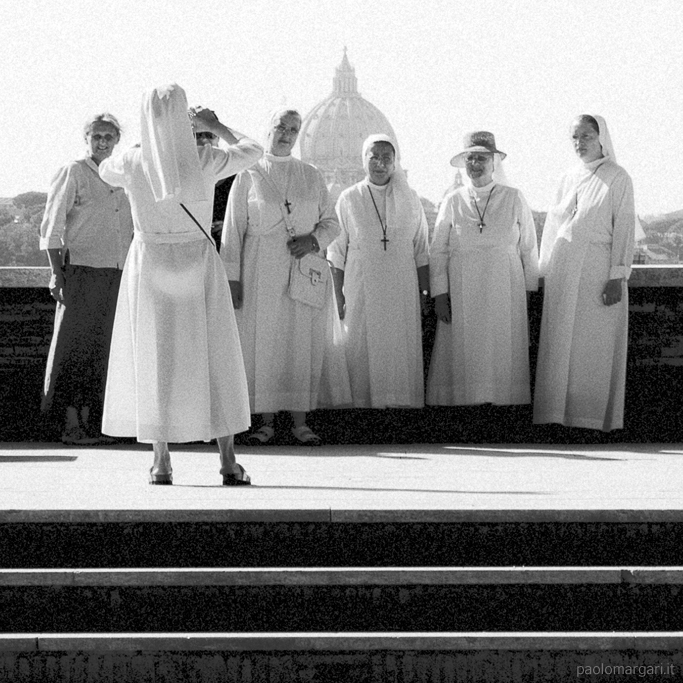 a group of people with white dresses and turbans