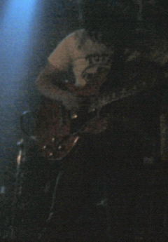 the band person playing guitar on stage