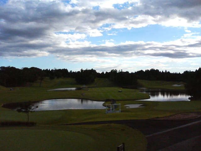 the cloudy sky and golf course is in view