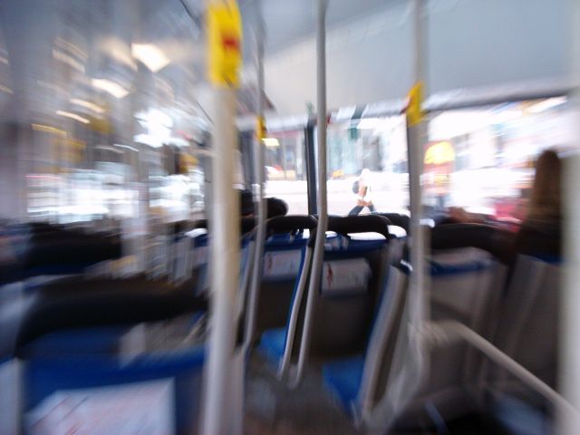 blurry image of seats and barriers on a train