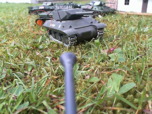 an image of several remote controlled battle tanks in the grass