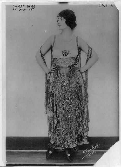 an old picture of a woman in a dress
