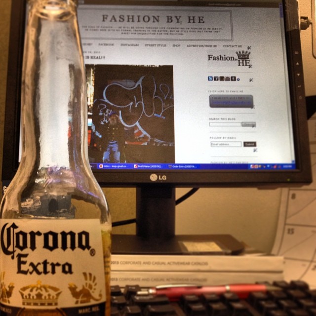 a computer with an extra bottle of corona beer in front of it