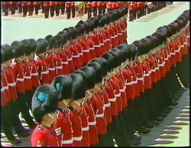 british soldiers standing at attention in red uniforms