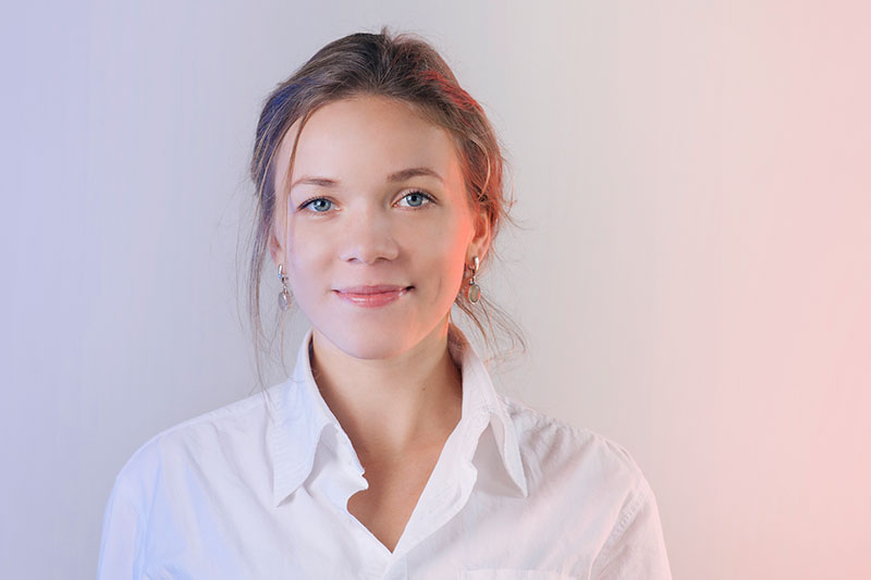 a smiling woman in a white shirt