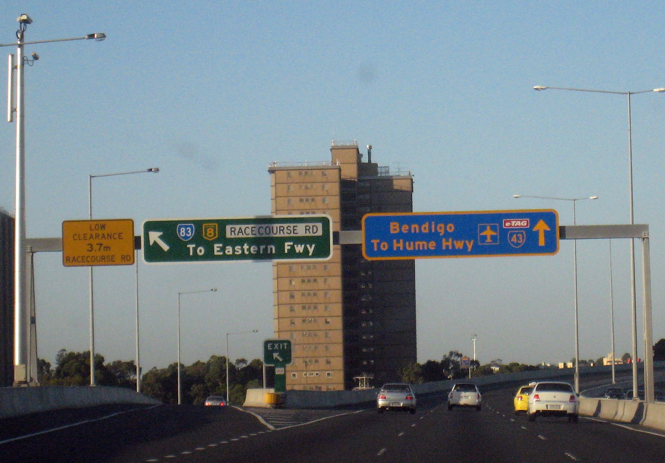 a busy freeway with a few street signs