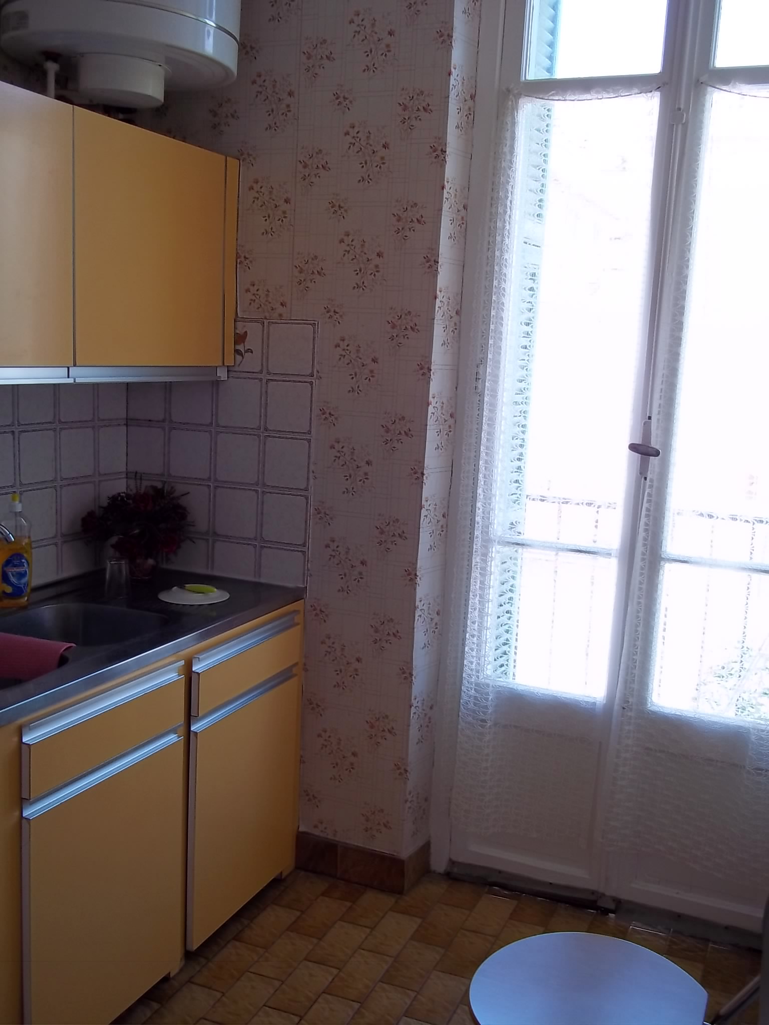 the kitchen has yellow cabinets and counter space