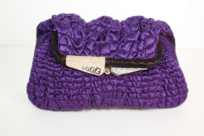 a purple clutch bag with a name tag on the front
