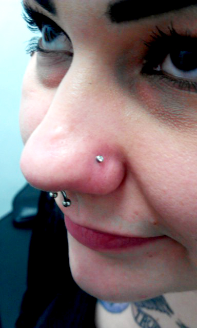 a girl with a piercing attached to her nose