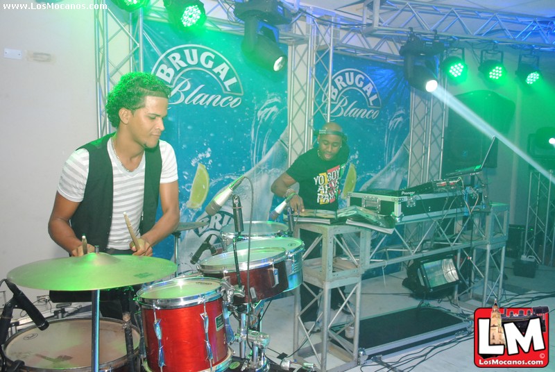 the drum players are playing music in front of green lights