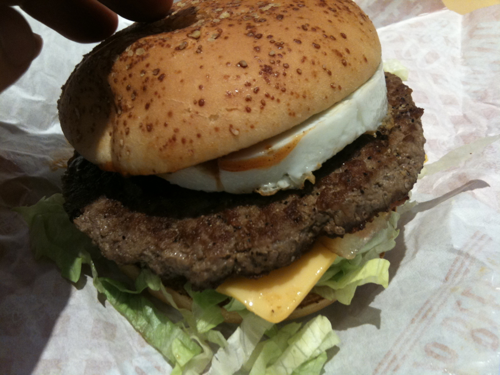 burger with large patty on top with lettuce and cheese