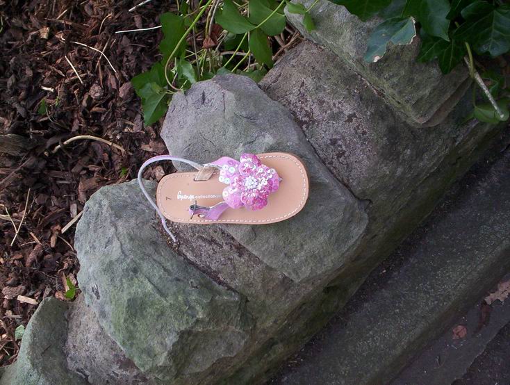 a pair of sandals with a flower attached