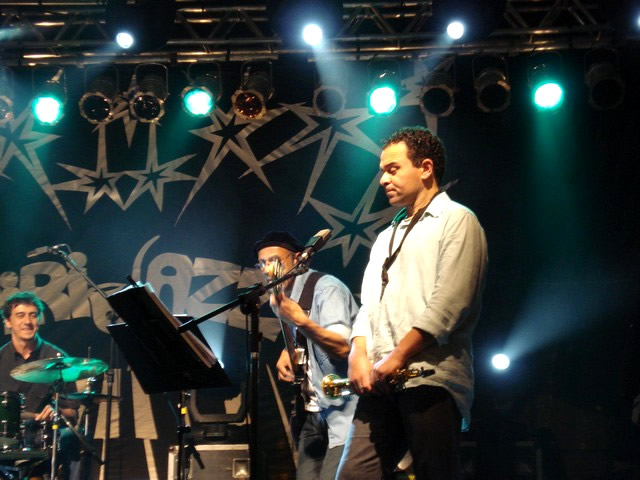 two men standing next to each other on stage