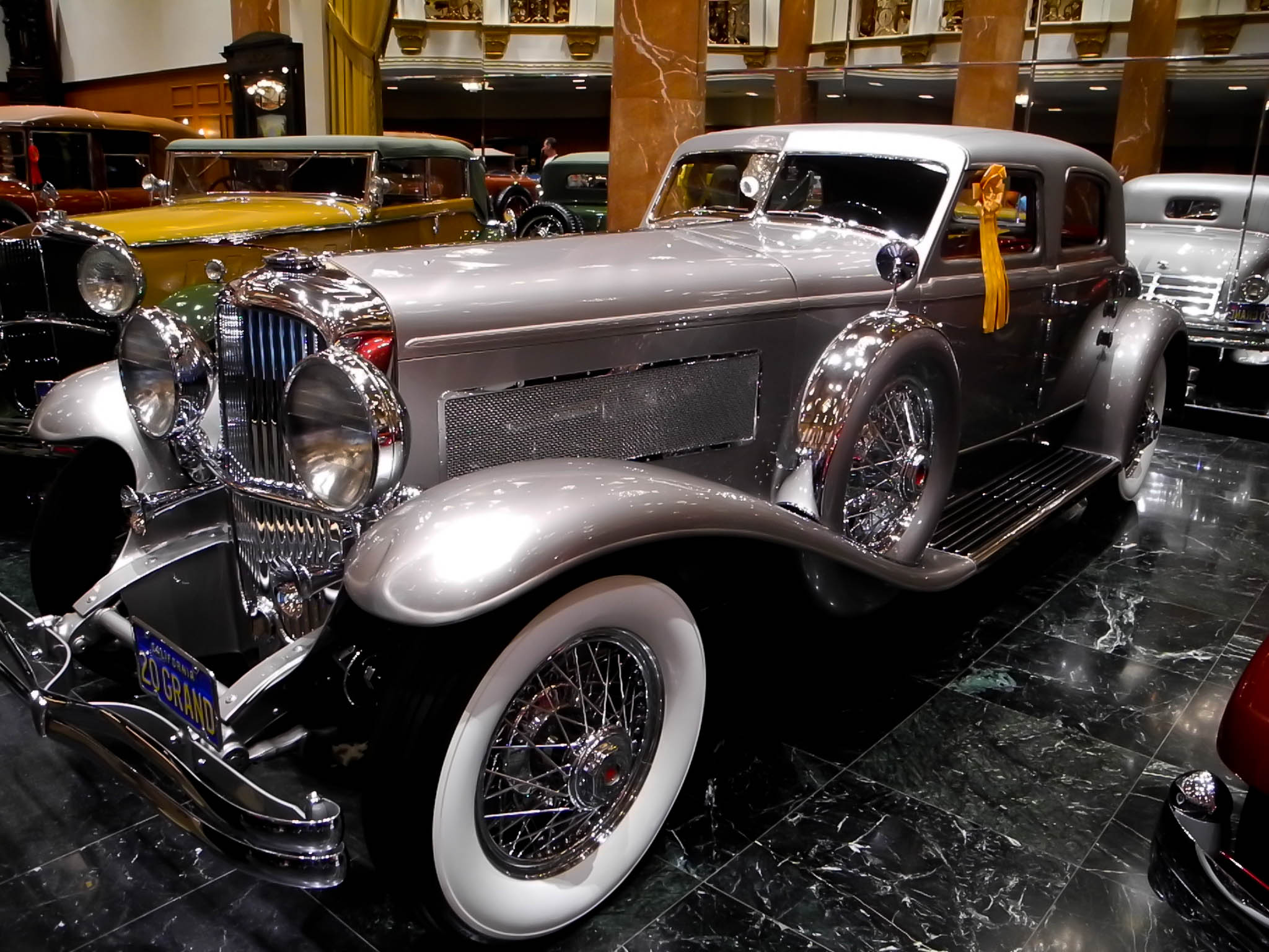 there is an old fashion car on display at a show