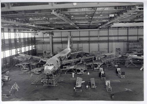 a large airplane being built inside of a hangar