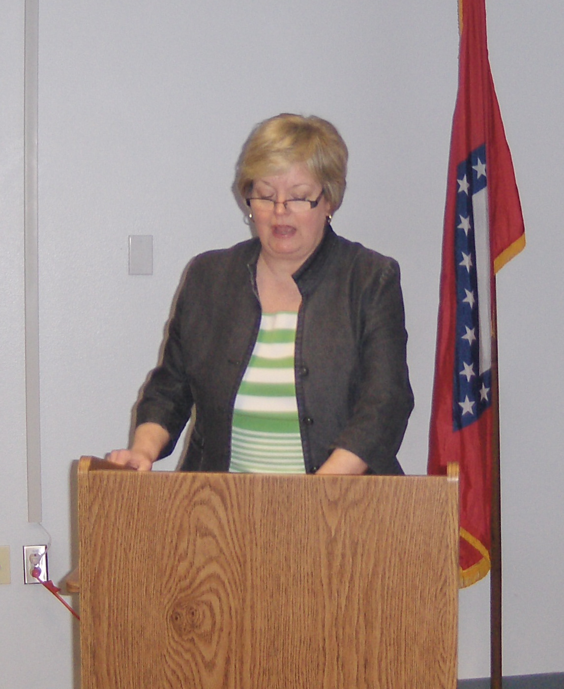 a lady giving a presentation at a podium
