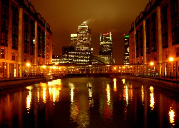 a waterway in the city at night with light reflections