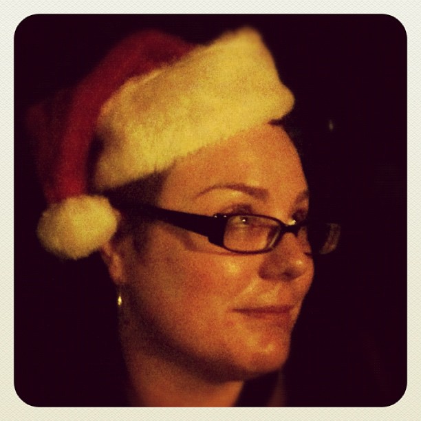 a woman wearing a santa hat and glasses