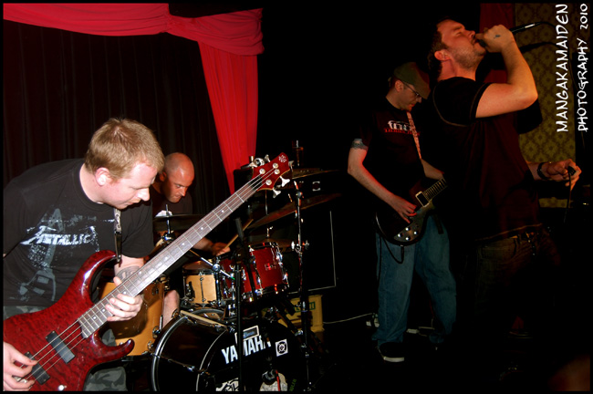 a group of men playing guitars in front of each other