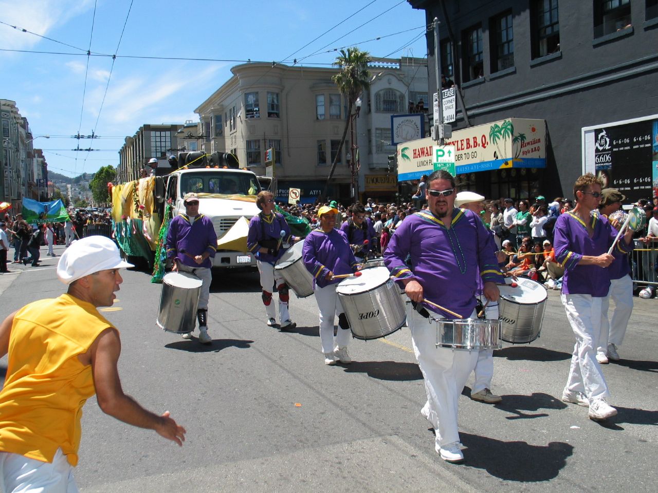 a group of people are playing drums in the street