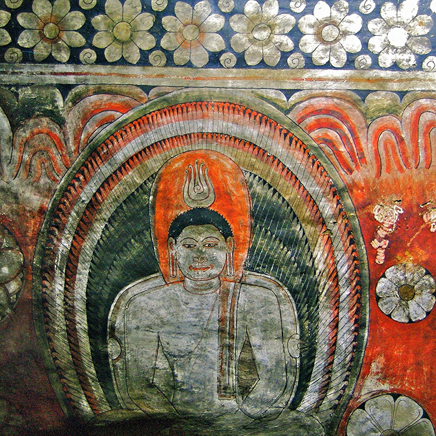 a cave painting with buddhist figures in it