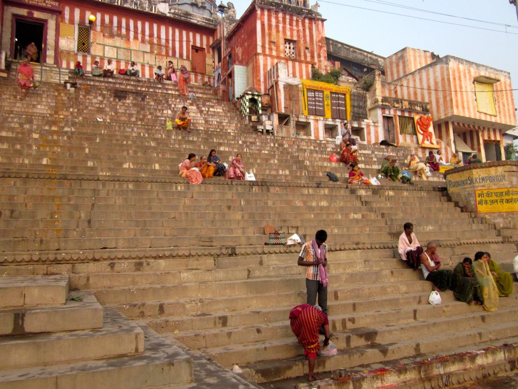 people sitting on the steps outside on their bikes