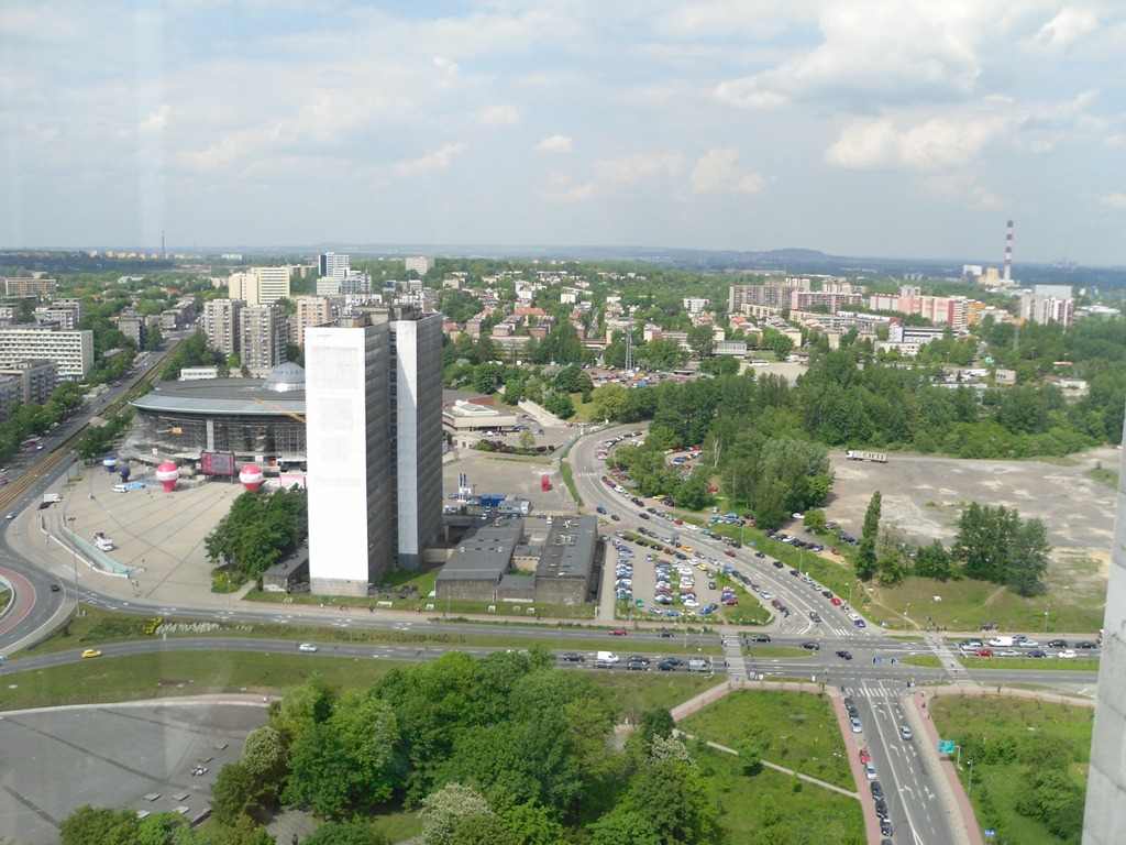 an aerial view of a city next to a highway