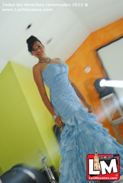a woman is posing in a light blue dress