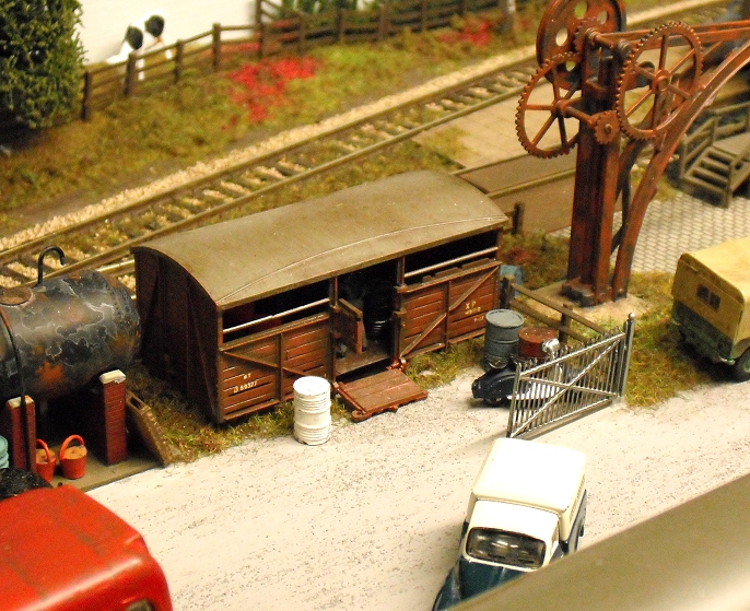small scale model railroad track with various objects on top