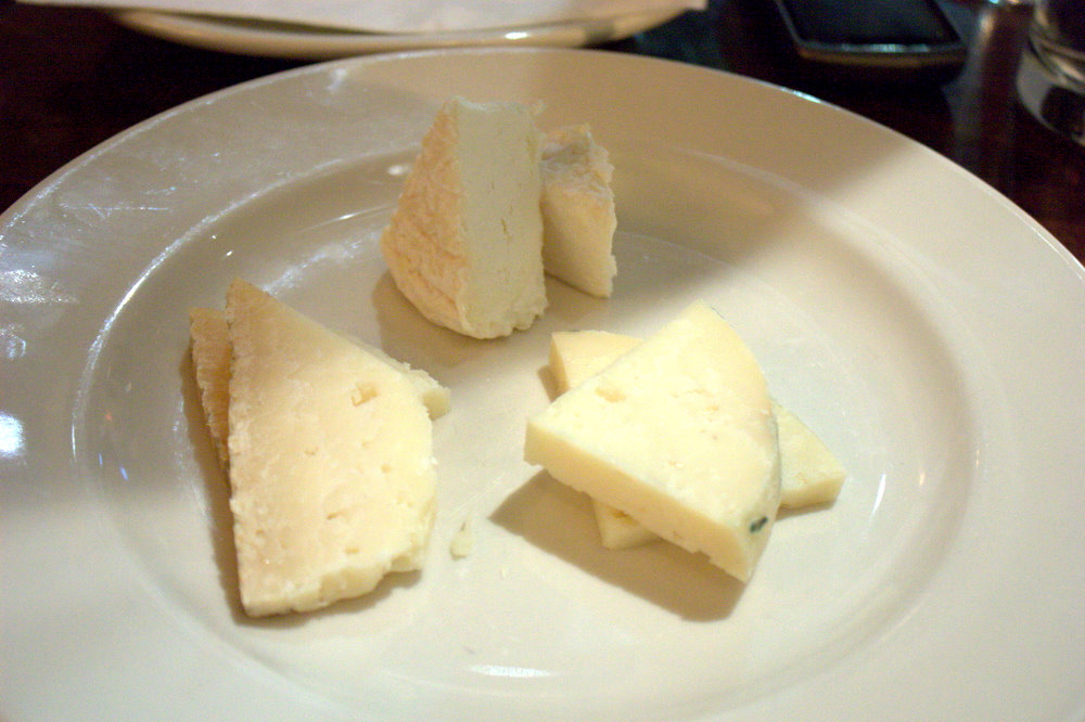 slices of cheese and cheesecake displayed on white plate