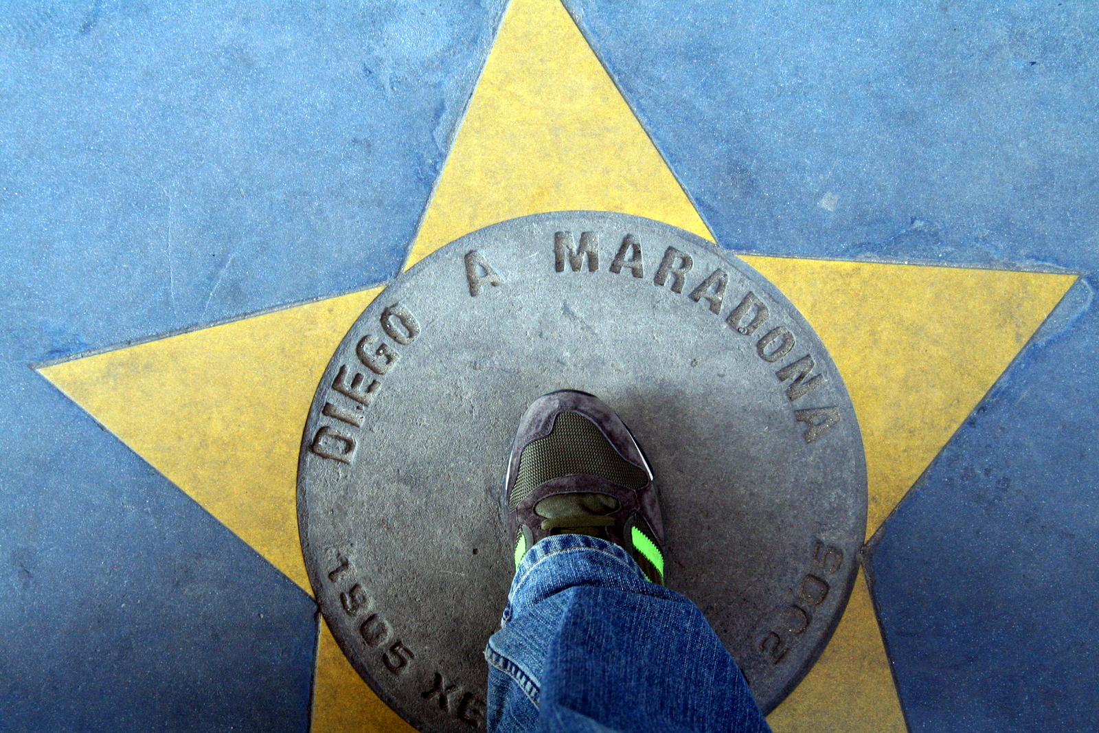 view of the foot and soles of a person standing by a star
