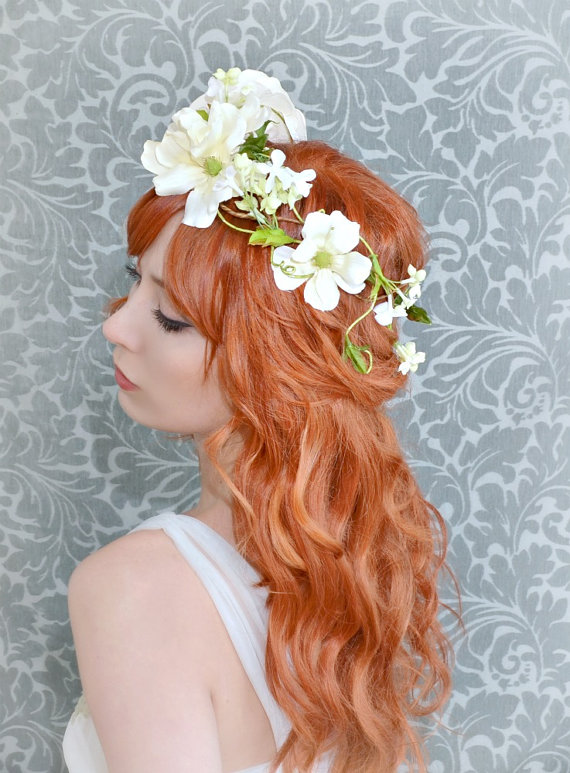 a beautiful woman with red hair wearing a flower crown