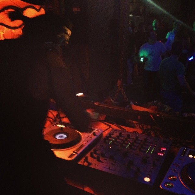 a dj is in a dark room with lights on