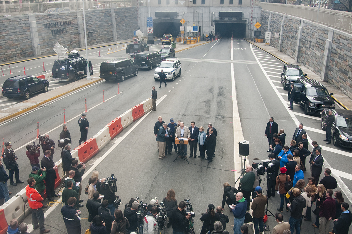 a group of people stand around an open bridge